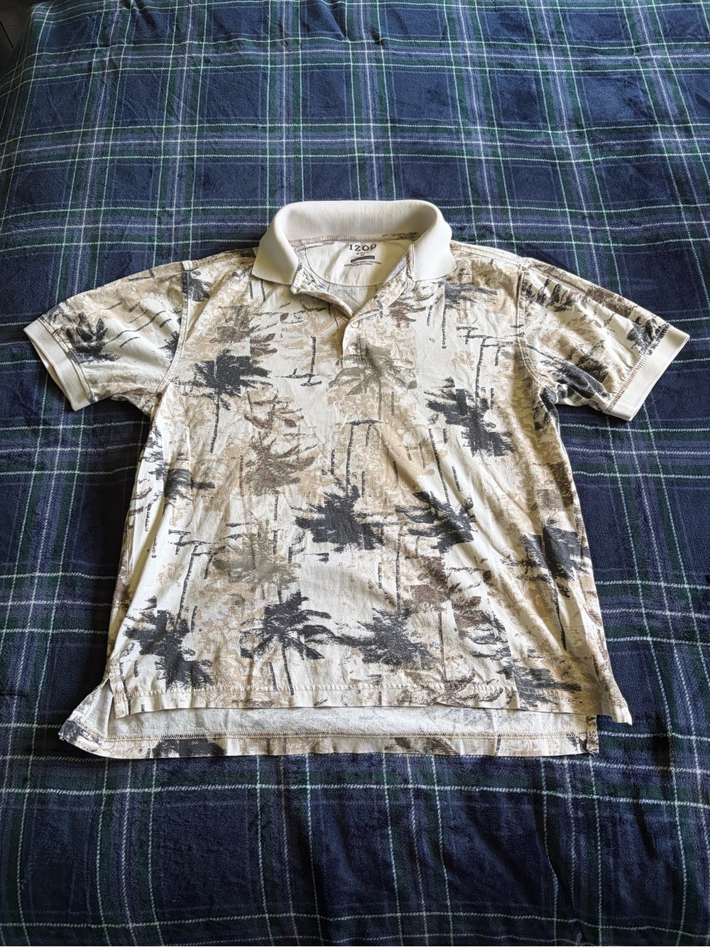 Izod Golf polo shirt with black palm tree print on beige background. Size S.
